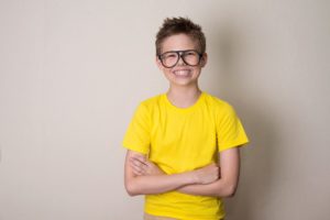 Boy with braces and black glasses
